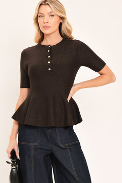 A woman modeling a short-sleeve knit top in dark brown with a buttoned henley neckline and a peplum hem | Flying Tomato