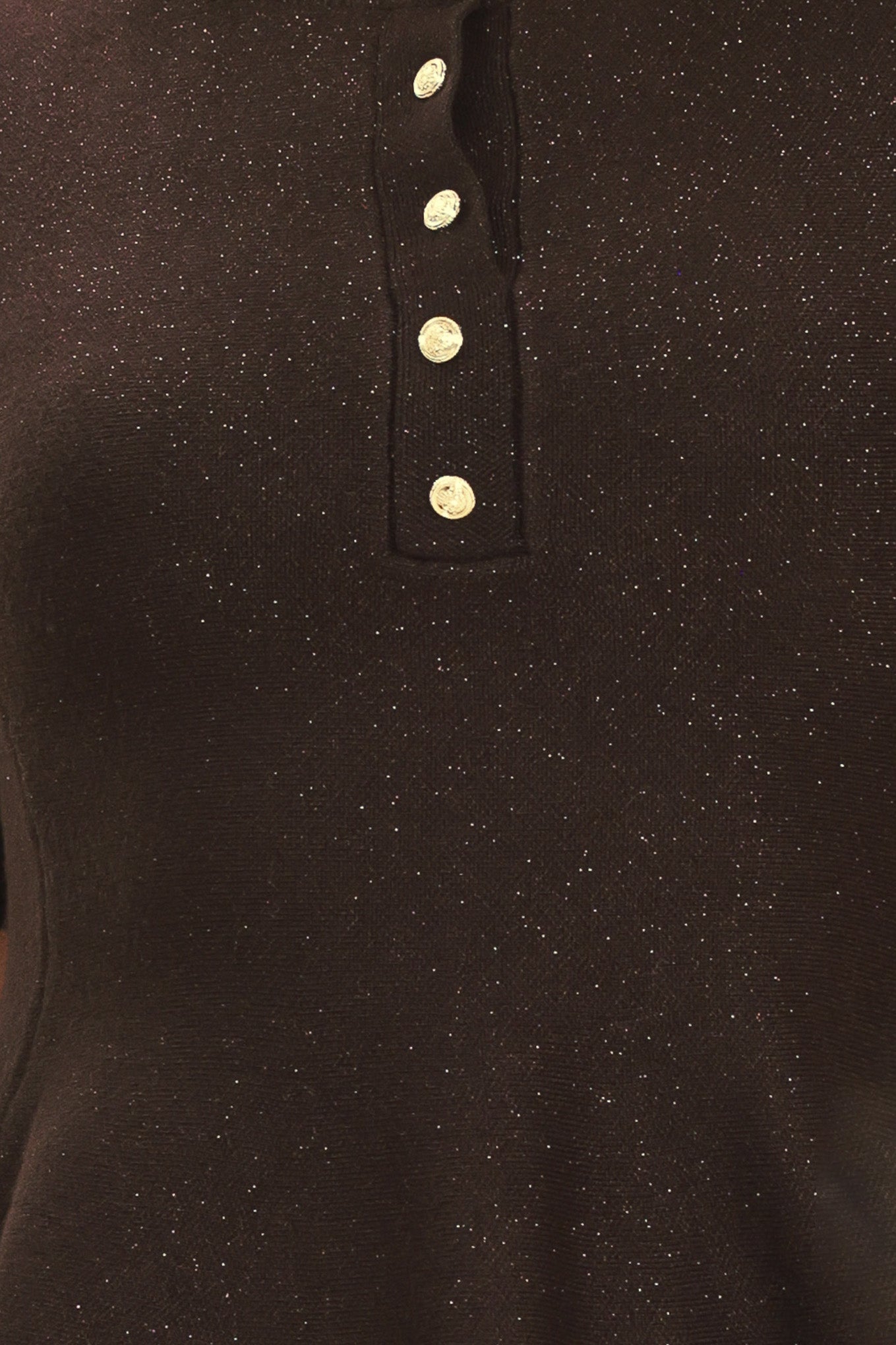 A woman modeling a short-sleeve knit top in dark brown with a buttoned henley neckline and a peplum hem | Flying Tomato