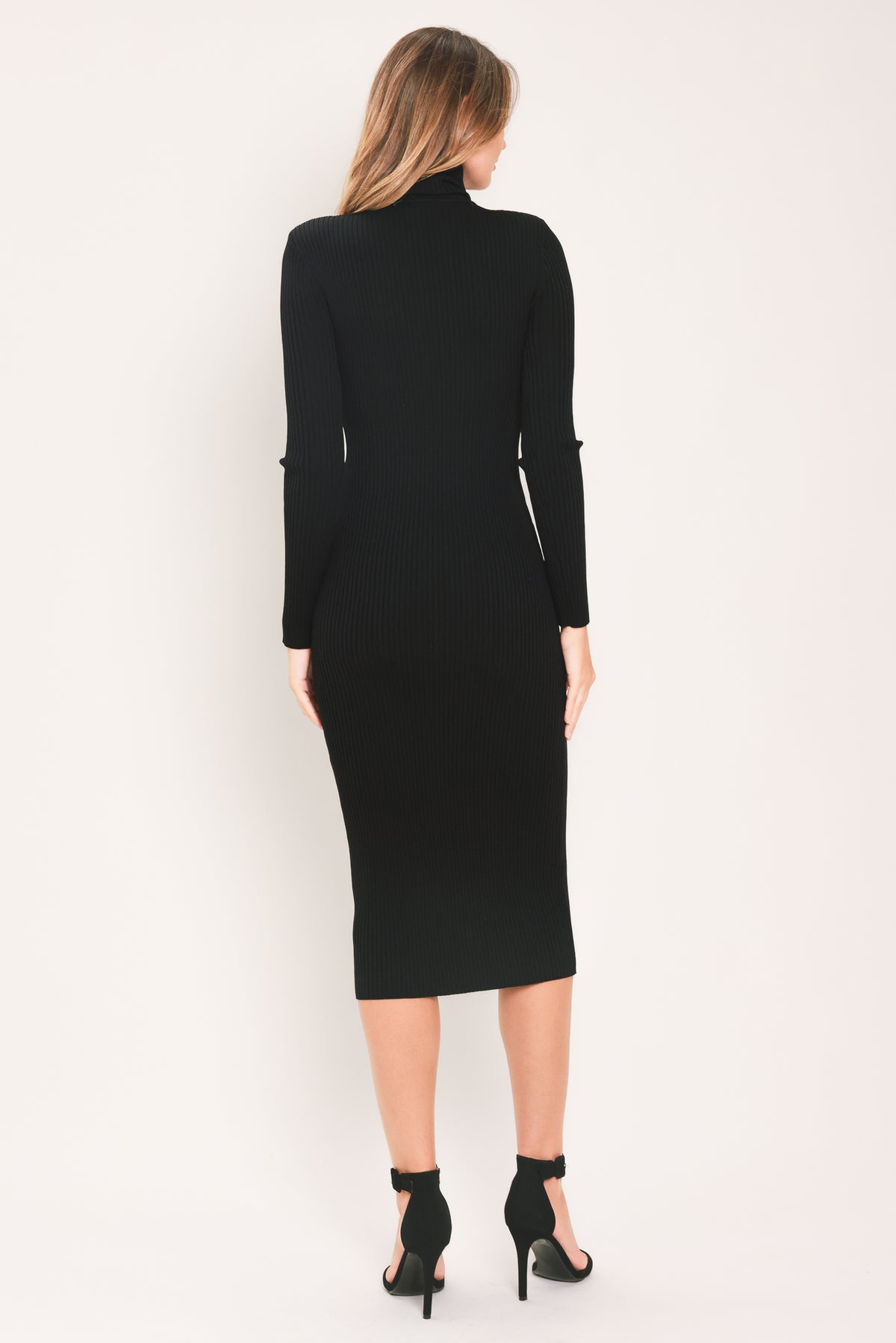 A woman modeling a black long-sleeve mock neck midi dress | Flying Tomato