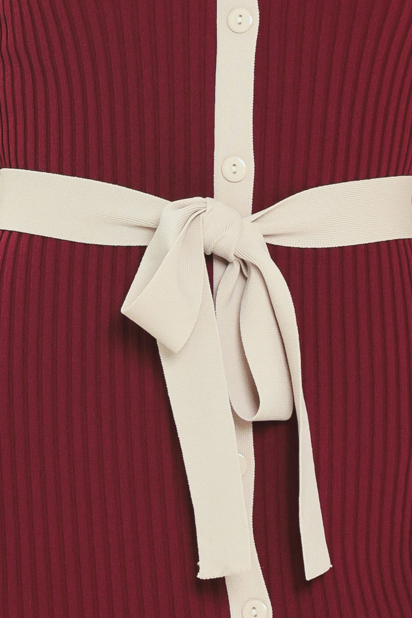A woman models a short-sleeve ribbed knit midi dress in deep burgundy with cream trim details, including the collar, front placket, and matching tie belt | Flying Tomato