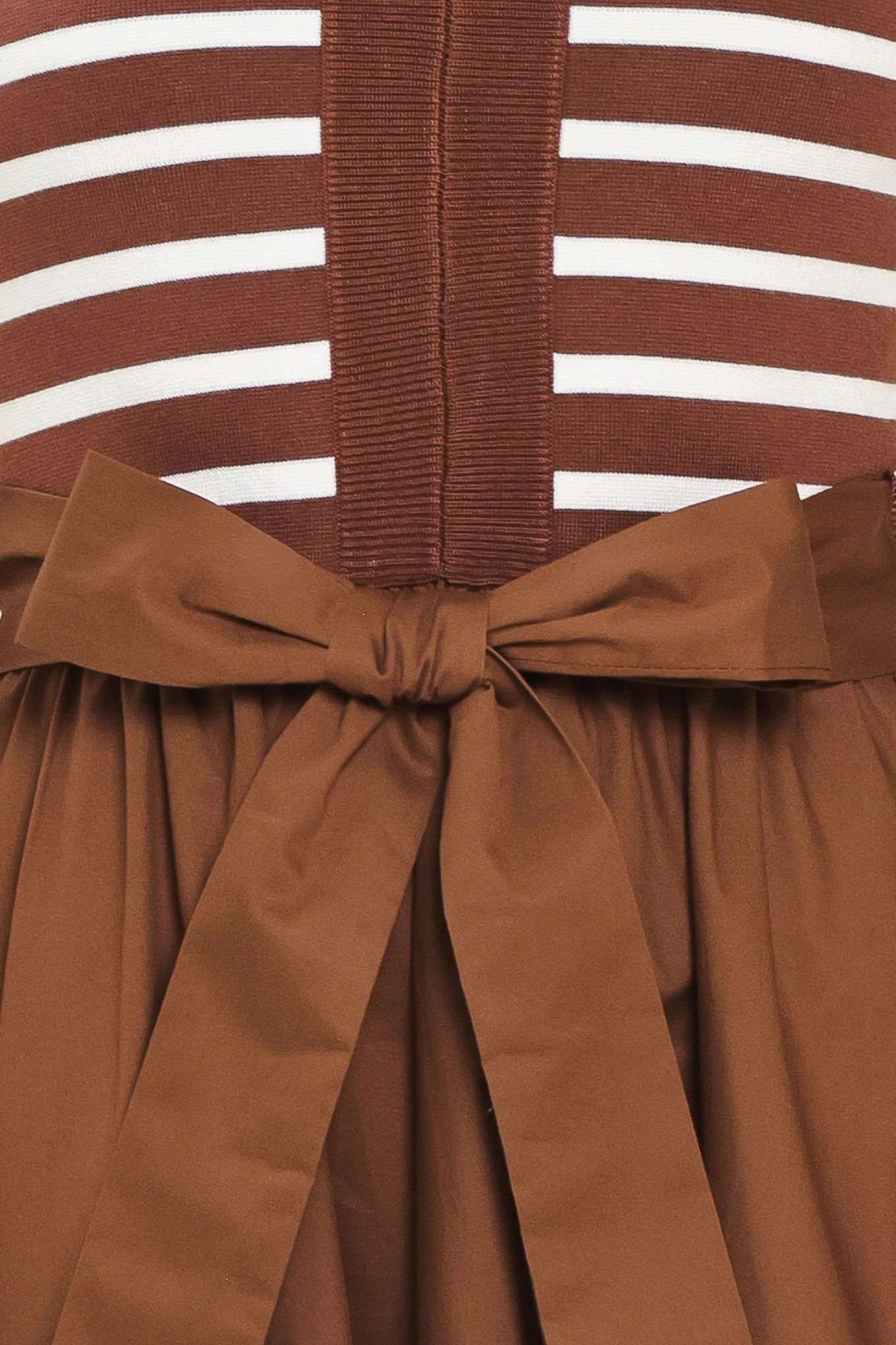 A woman wearing a sleeveless midi dress with brown and white striped top and solid brown skirt featuring a matching tie belt | Flying Tomato