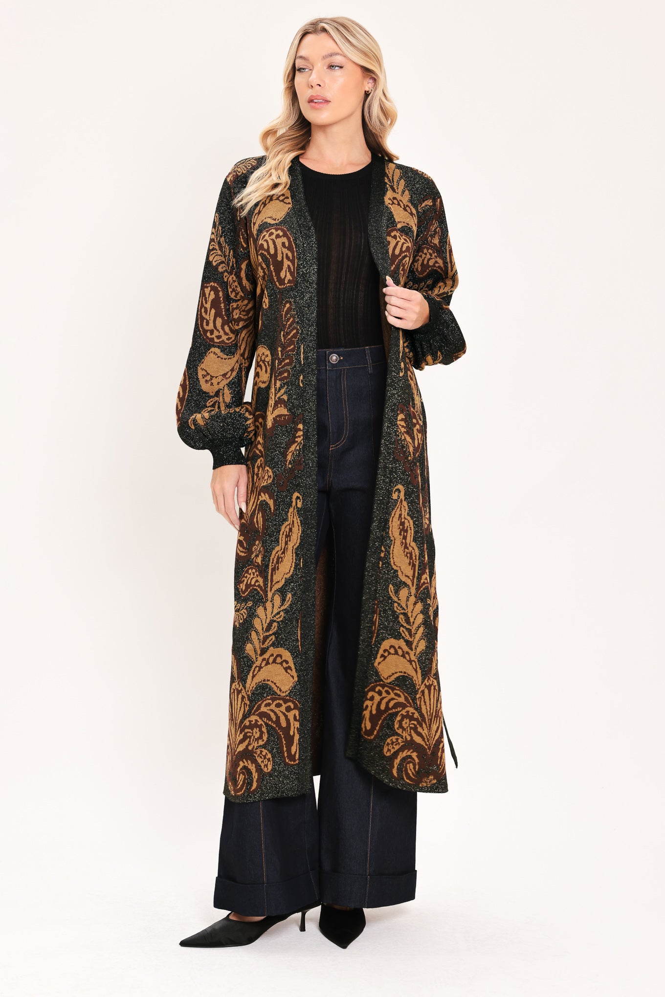 A woman modeling a long black cardigan with a brown baroque-style floral pattern | Flying Tomato