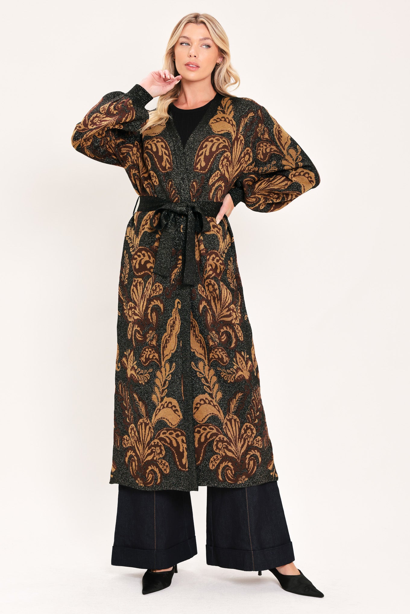 A woman modeling a long black cardigan with a brown baroque-style floral pattern | Flying Tomato