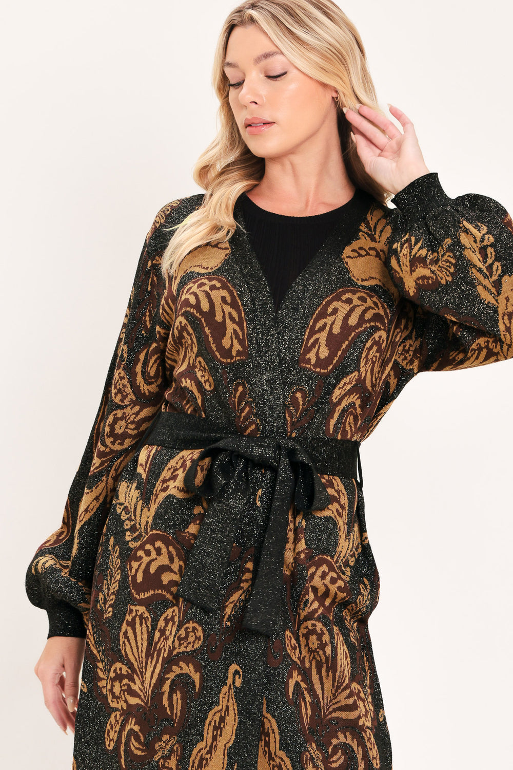 A woman modeling a long black cardigan with a brown baroque-style floral pattern | Flying Tomato