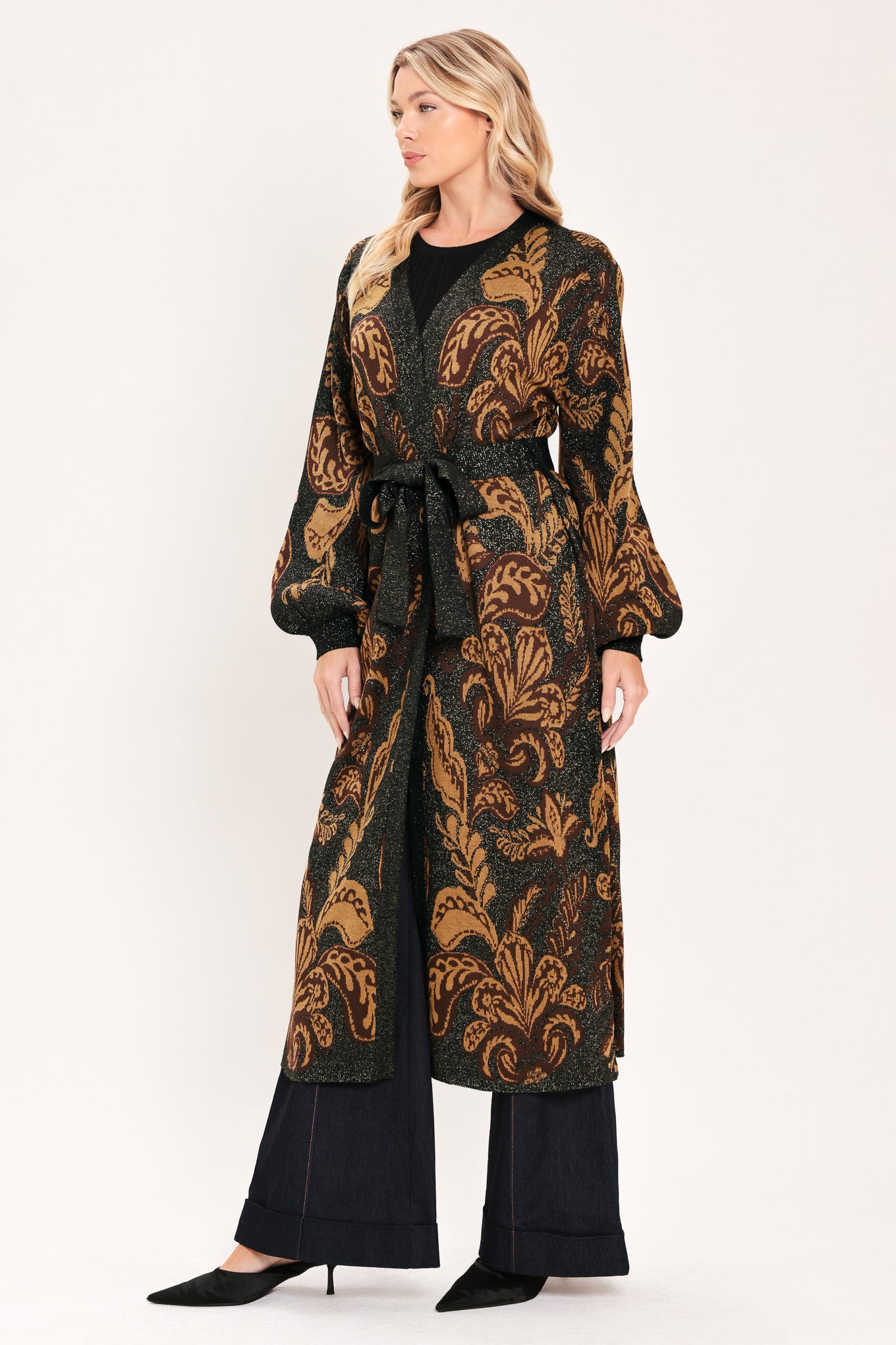 A woman modeling a long black cardigan with a brown baroque-style floral pattern | Flying Tomato