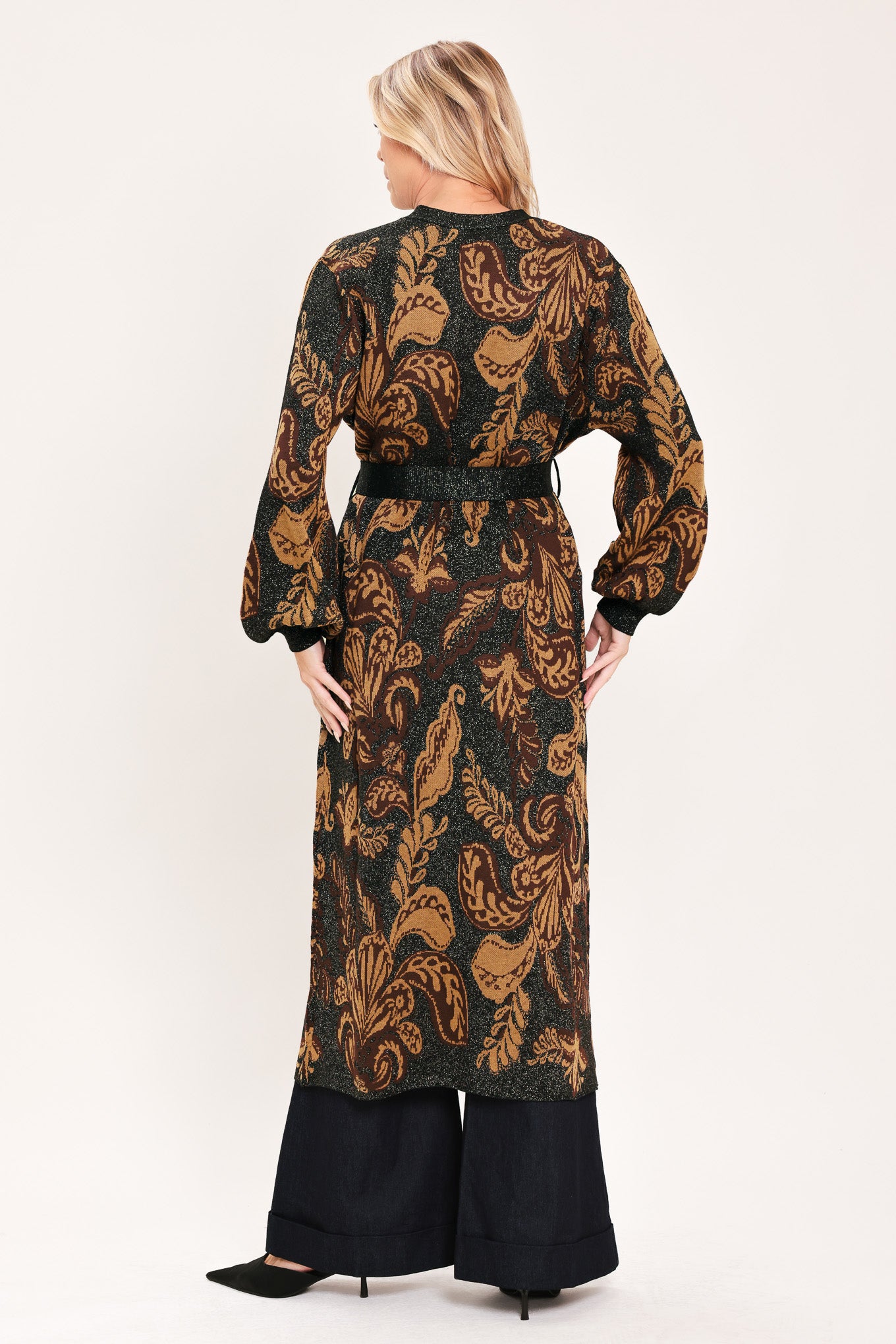A woman modeling a long black cardigan with a brown baroque-style floral pattern | Flying Tomato
