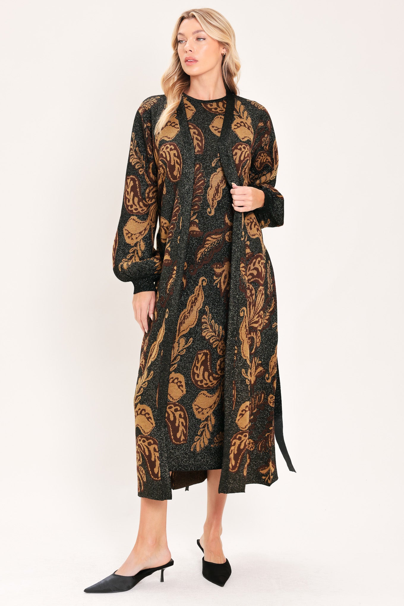 A woman modeling a long black cardigan with a brown baroque-style floral pattern | Flying Tomato