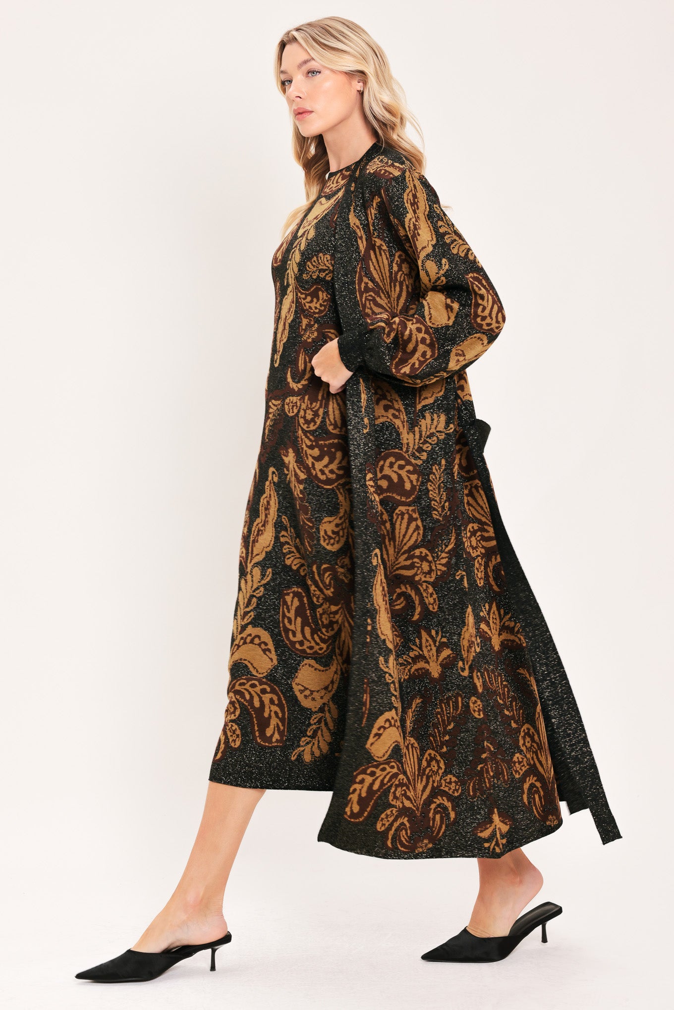 A woman modeling a long black cardigan with a brown baroque-style floral pattern | Flying Tomato