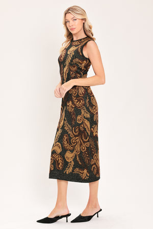 A woman modeling a sleeveless midi dress with a black base and an intricate gold metallic botanical and scroll pattern | Flying Tomato