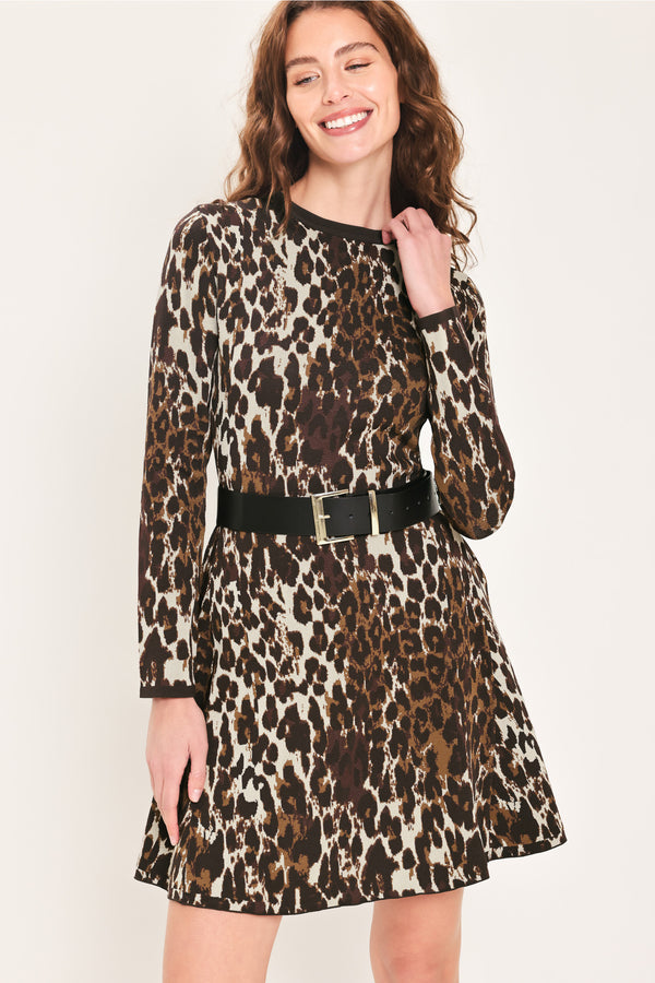 Woman wearing a long sleeve leopard print knitted sweater mini dress with a black belt and round neckline | Flying Tomato