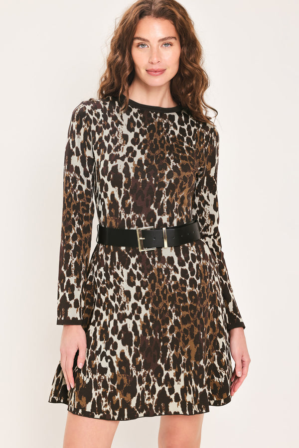 Woman wearing a long sleeve leopard print knitted sweater mini dress with a black belt and round neckline | Flying Tomato