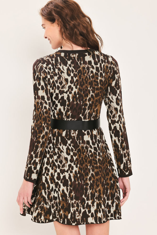 Woman wearing a long sleeve leopard print knitted sweater mini dress with a black belt and round neckline | Flying Tomato
