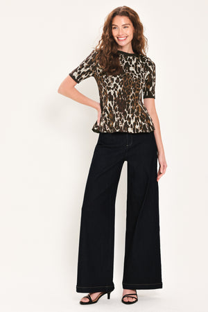Woman wearing a short sleeve leopard print knitted sweater top with round neckline and peplum waist | Flying Tomato
