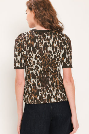 Woman wearing a short sleeve leopard print knitted sweater top with round neckline and peplum waist | Flying Tomato