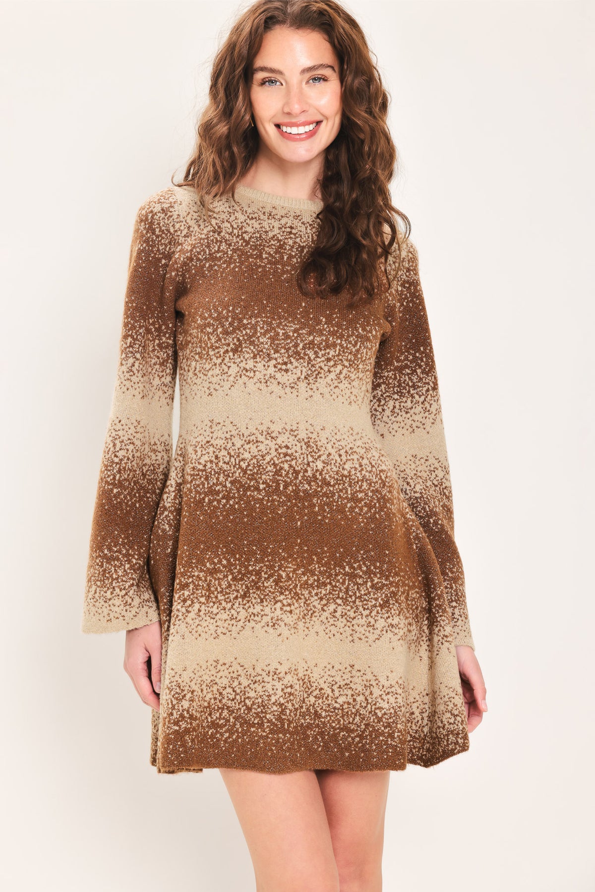 Woman wearing a brown and beige sweater knit flared mini dress with long sleeves | Flying Tomato
