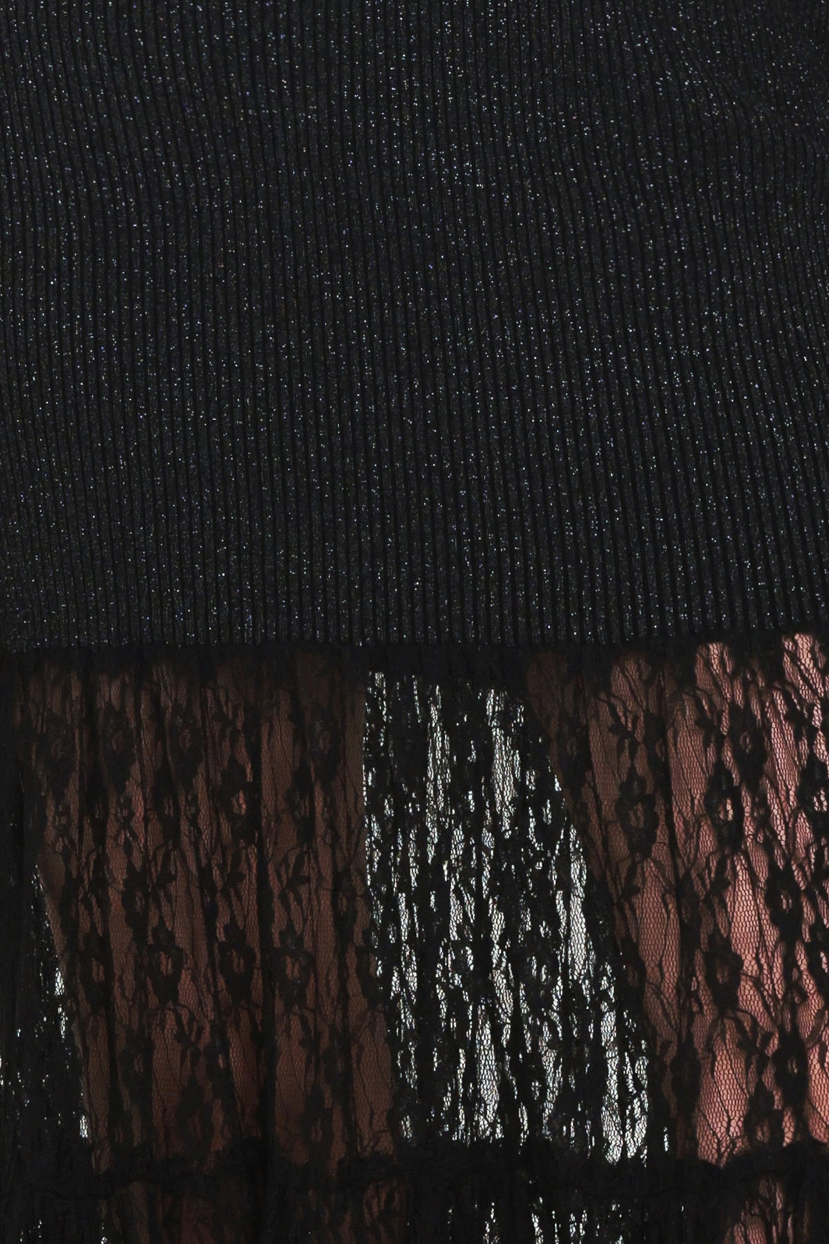 Woman wearing a long sleeve black sweater knit maxi dress but the sweater portion stops at the thighs and the bottom of the dress is tiered lace | Flying Tomato