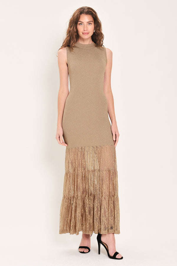 Woman wearing a sleeveless mock neck beige/gold metallic maxi dress with lace tiered skirt starting at the thighs | Flying Tomato