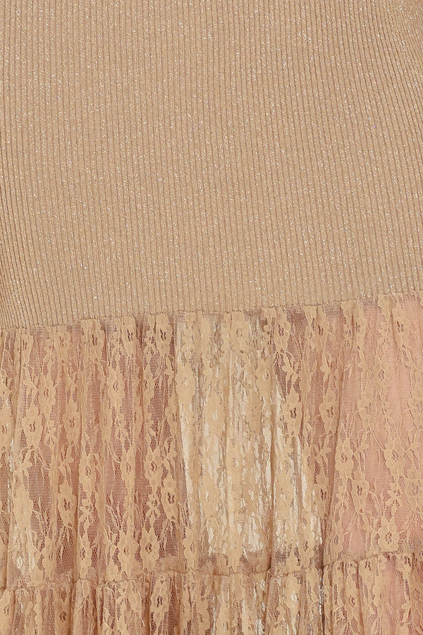 Woman wearing a sleeveless mock neck beige/gold metallic maxi dress with lace tiered skirt starting at the thighs | Flying Tomato