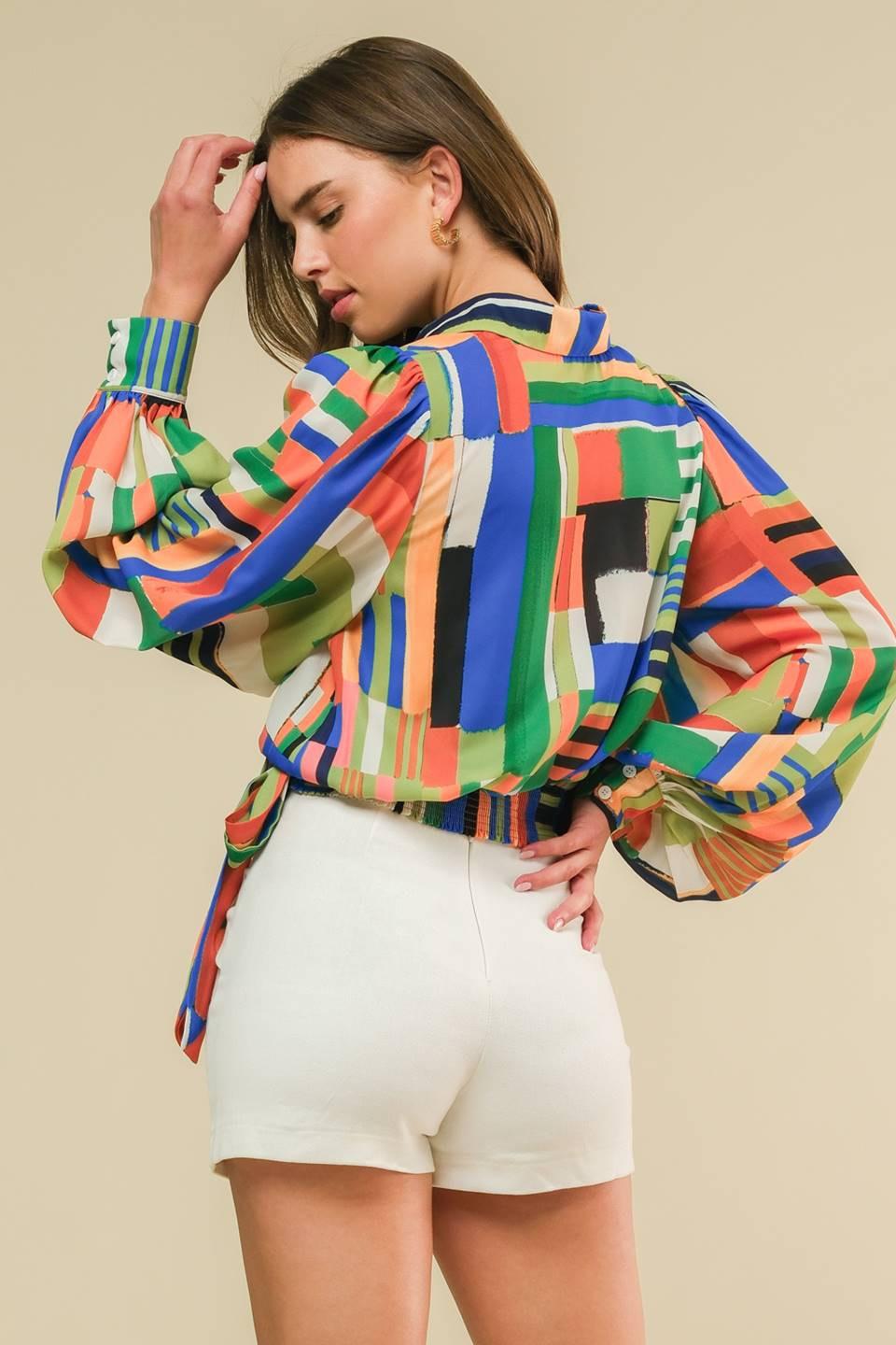 A printed woven top featuring shirt collar, surplice neckline, side tie, blouson long sleeve and smocked back waist band
Details:
Self : 100% Polyester
Size & Fit
- Model is 5`8" And Wearing Size Small
- Measurements Taken From Size Small
- Approx. Length: 21"