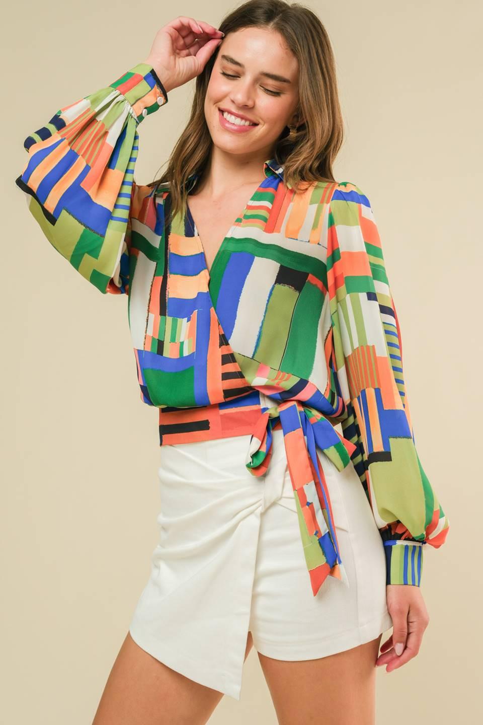 A printed woven top featuring shirt collar, surplice neckline, side tie, blouson long sleeve and smocked back waist band
Details:
Self : 100% Polyester
Size & Fit
- Model is 5`8" And Wearing Size Small
- Measurements Taken From Size Small
- Approx. Length: 21"