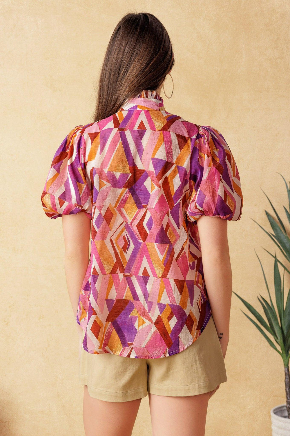 
A printed woven top featuring high neckline with ruffled edge, short puff sleeve and button down

Details:

Self : 100% Polyester
Lining: 100% Polyester

Size &amp; Fit

- Model is 5`7" And Wearing Size Small
- Measurements Taken From Size Small
- Approx. Length: 24"