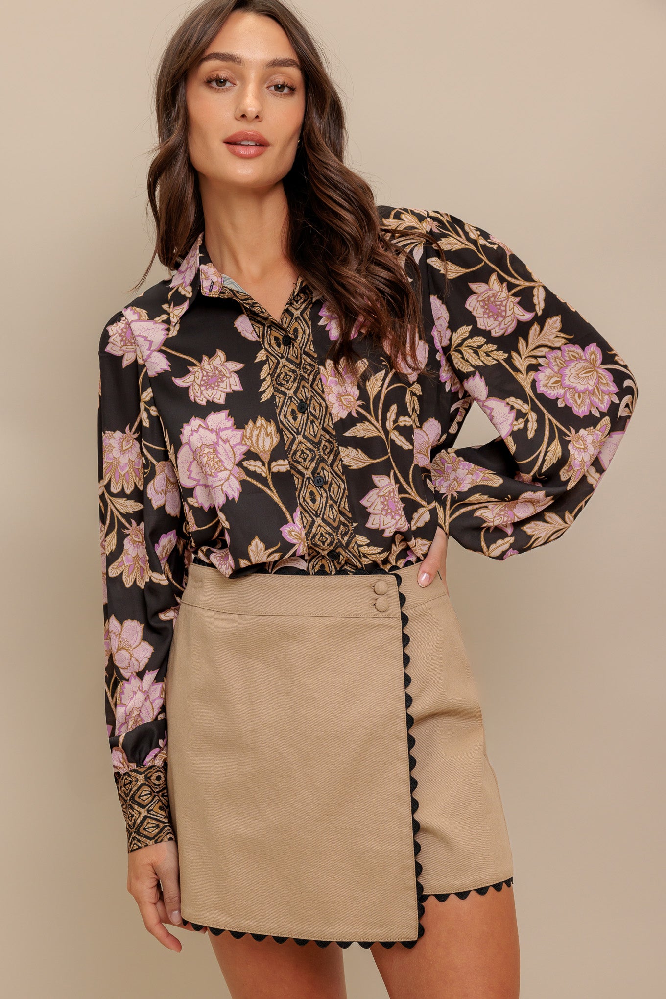 A printed woven top with front button down and long sleeve