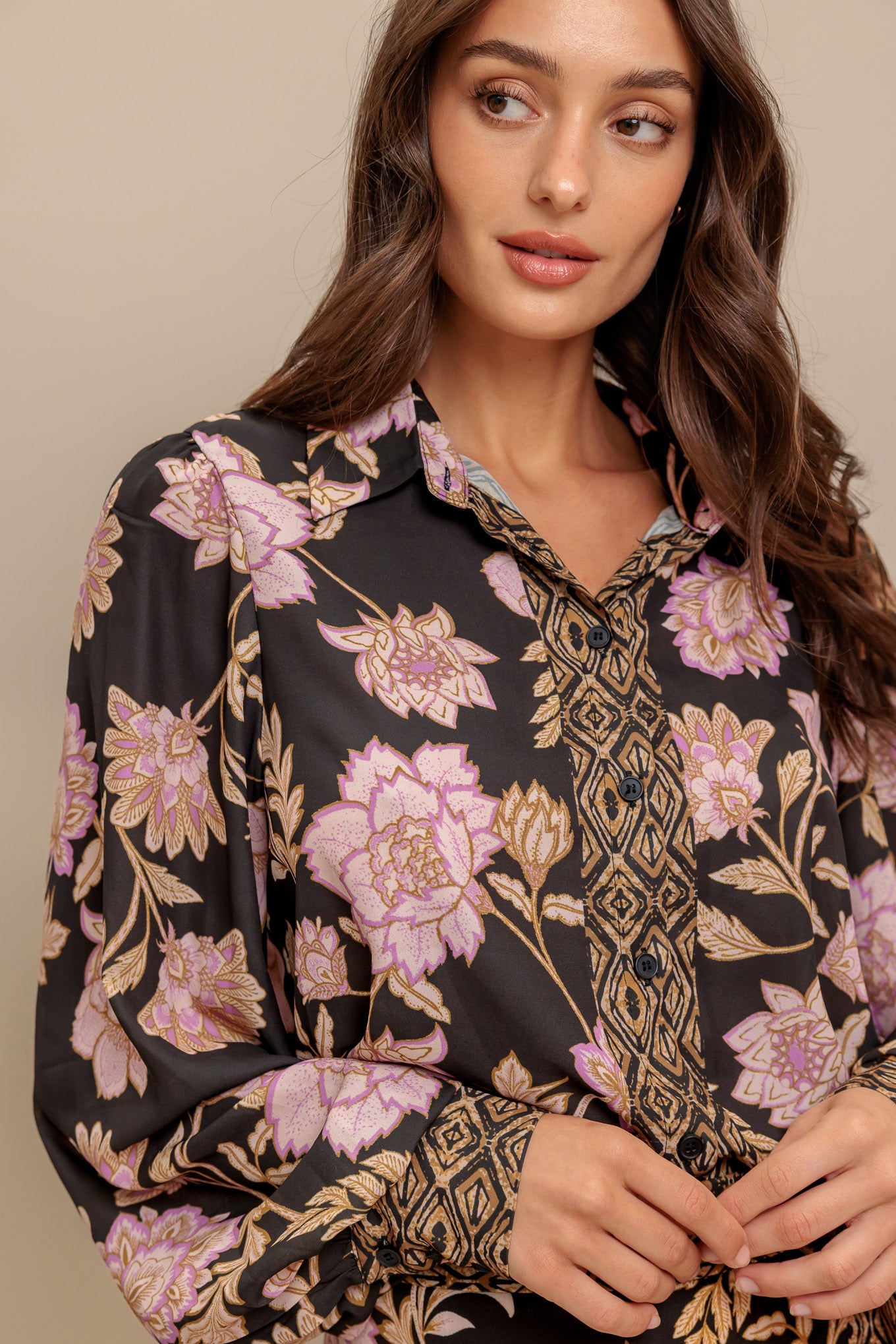 A printed woven top with front button down and long sleeve