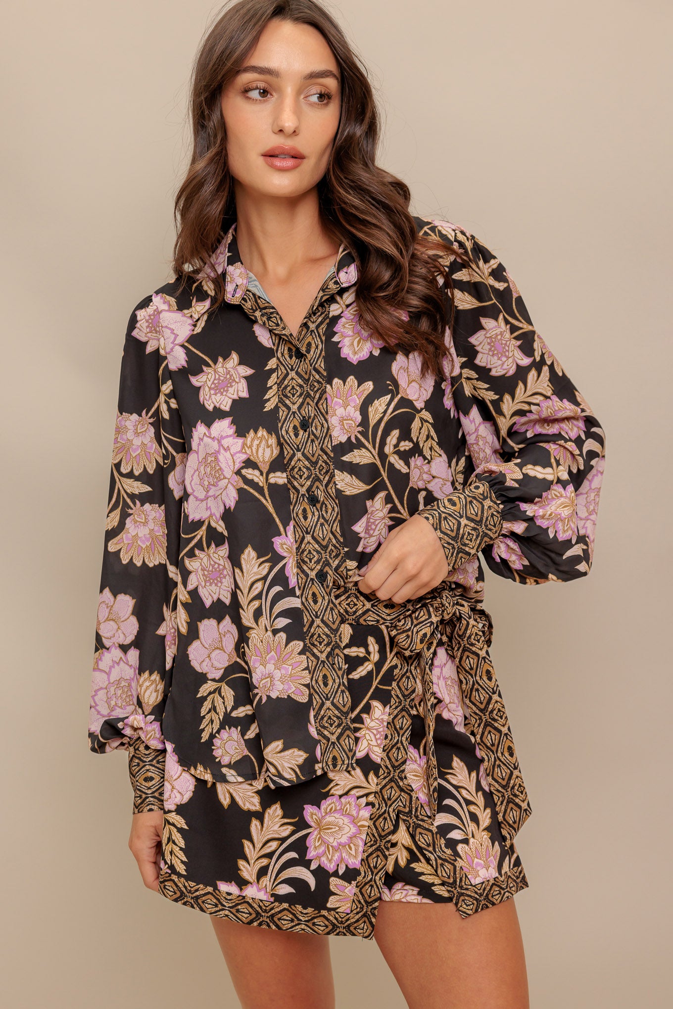 A printed woven top with front button down and long sleeve