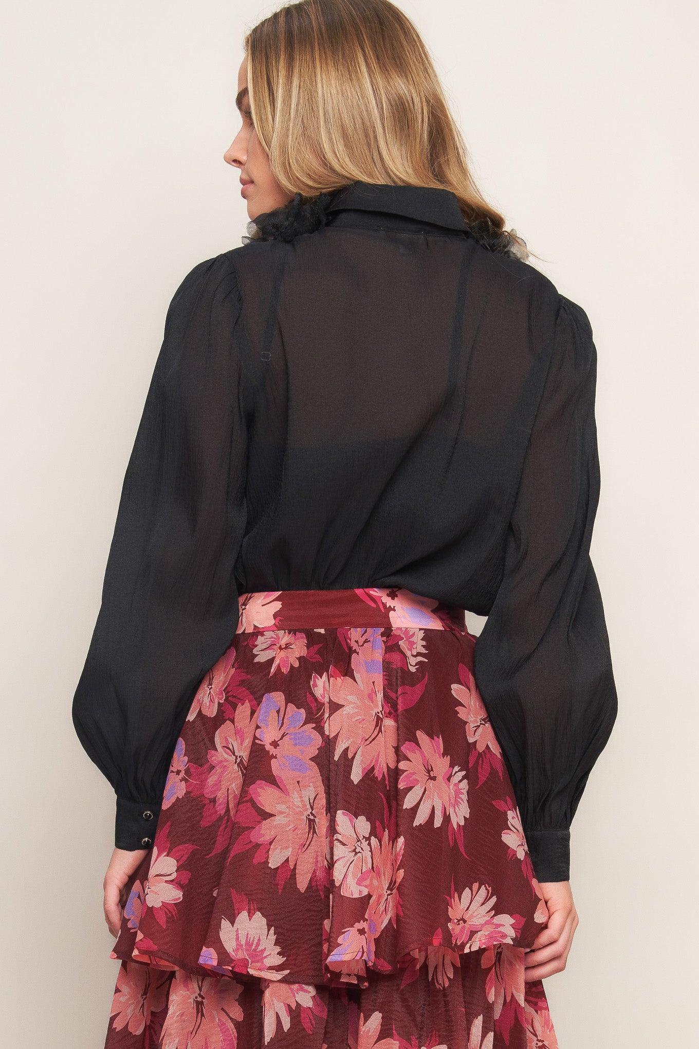 A solid woven top featuring shirt collar, button down, floral embellished front and long sleeve