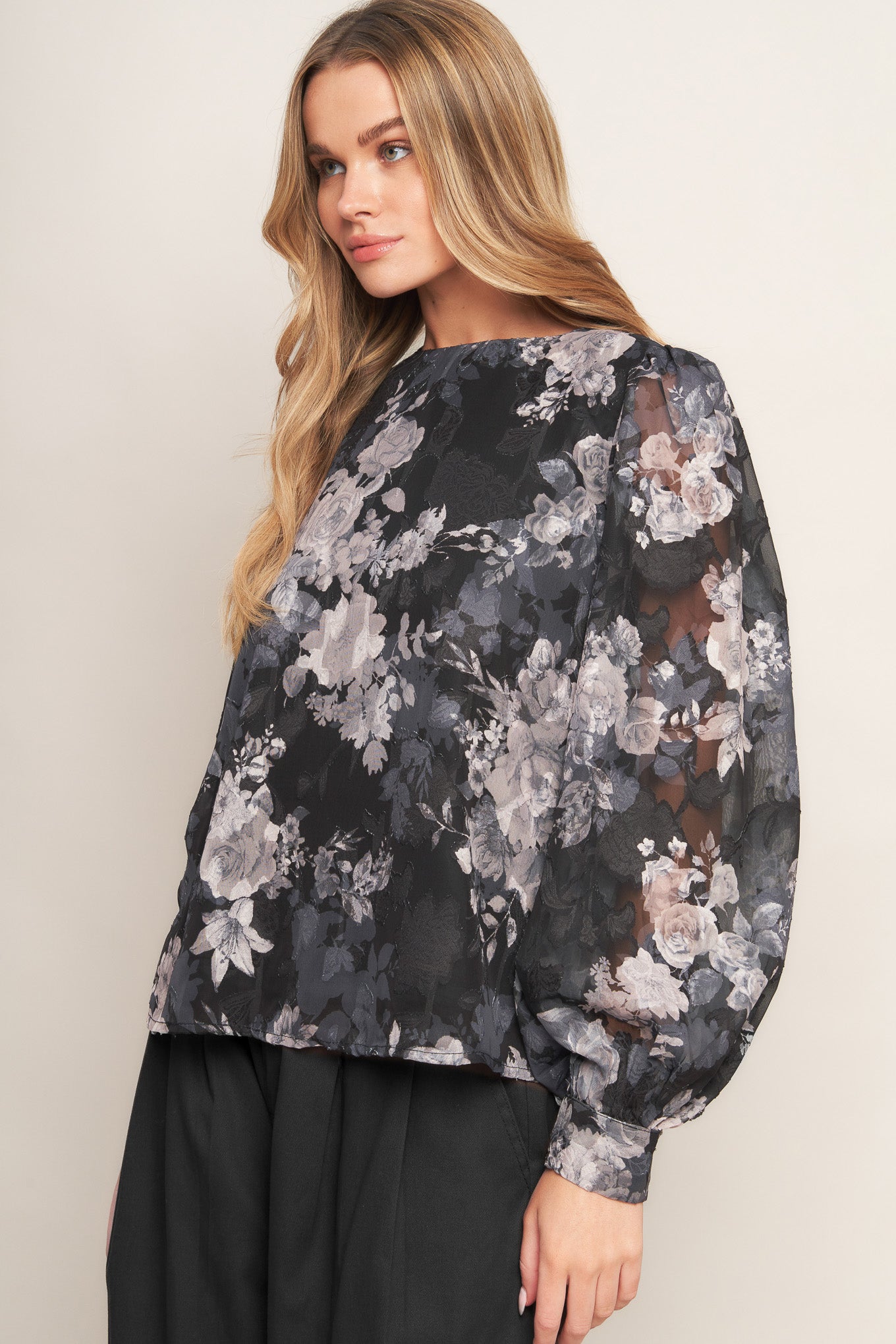 A printed woven top featuring round neckline, long sleeve and back bow tie detail