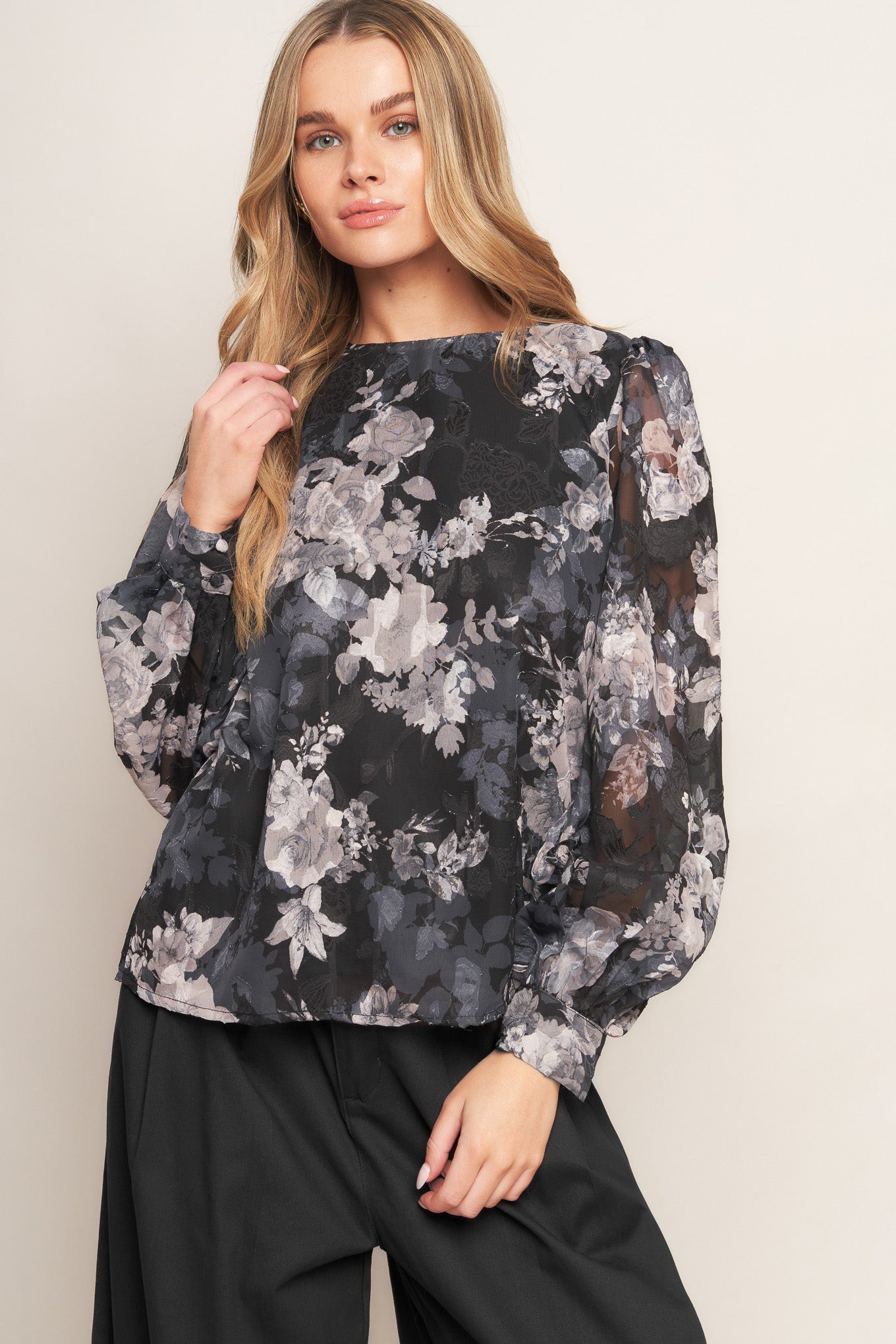 A printed woven top featuring round neckline, long sleeve and back bow tie detail