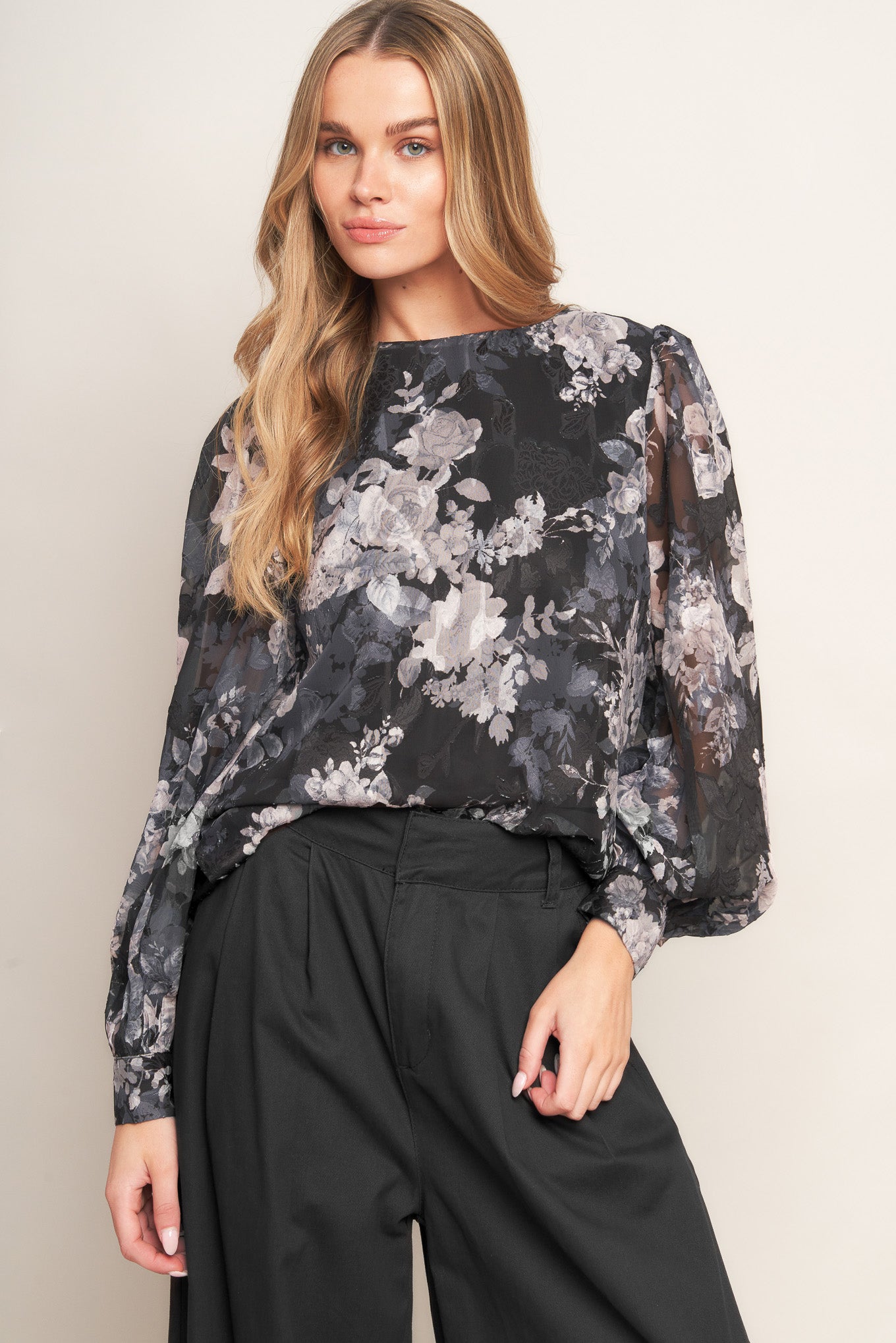 A printed woven top featuring round neckline, long sleeve and back bow tie detail
