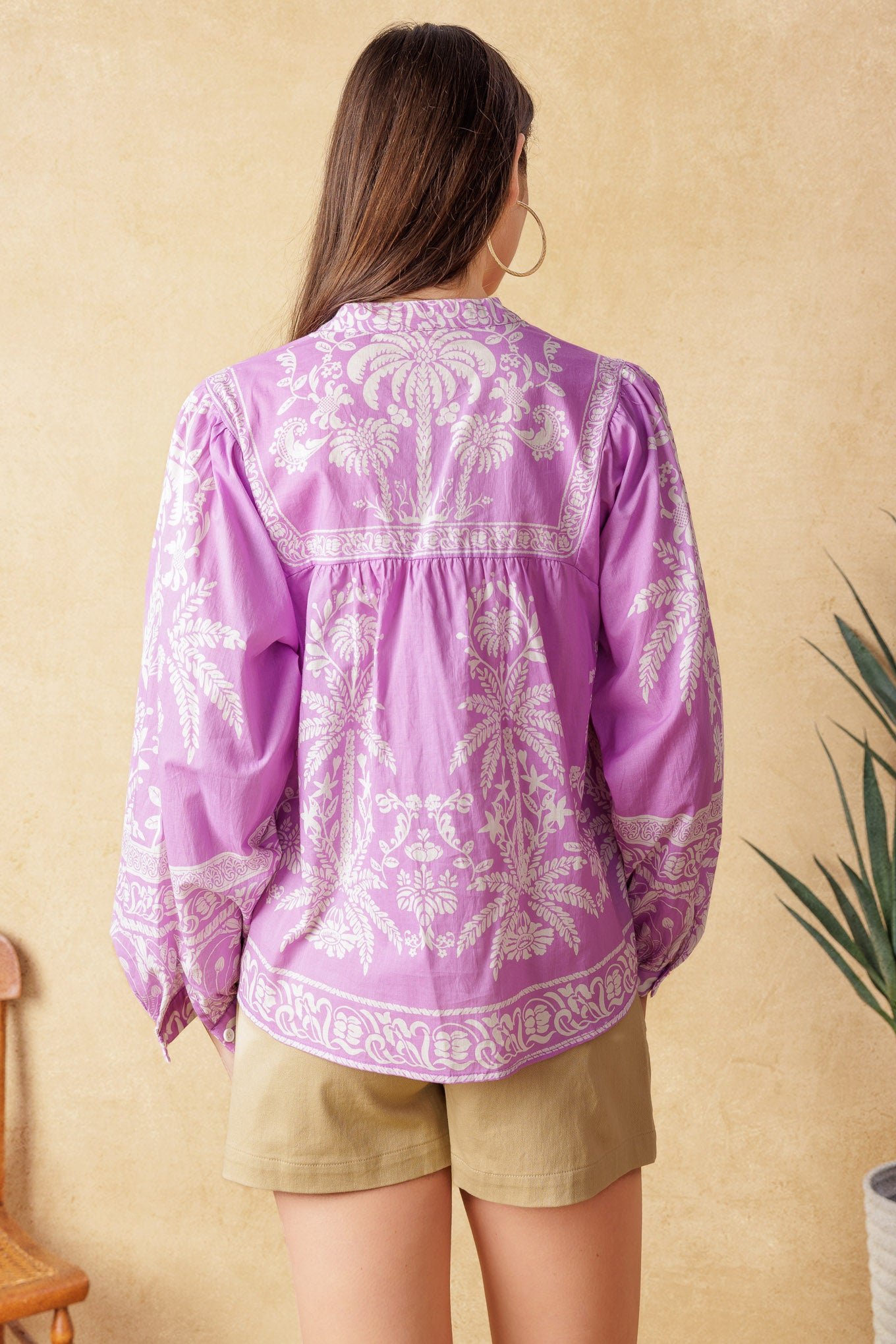 Elevate your style with this chic woven top adorned with a unique print. The china collar and front tie add an elegant touch while the long sleeves keep you warm. Perfect for a city getaway, this top will make you stand out in the crowd.