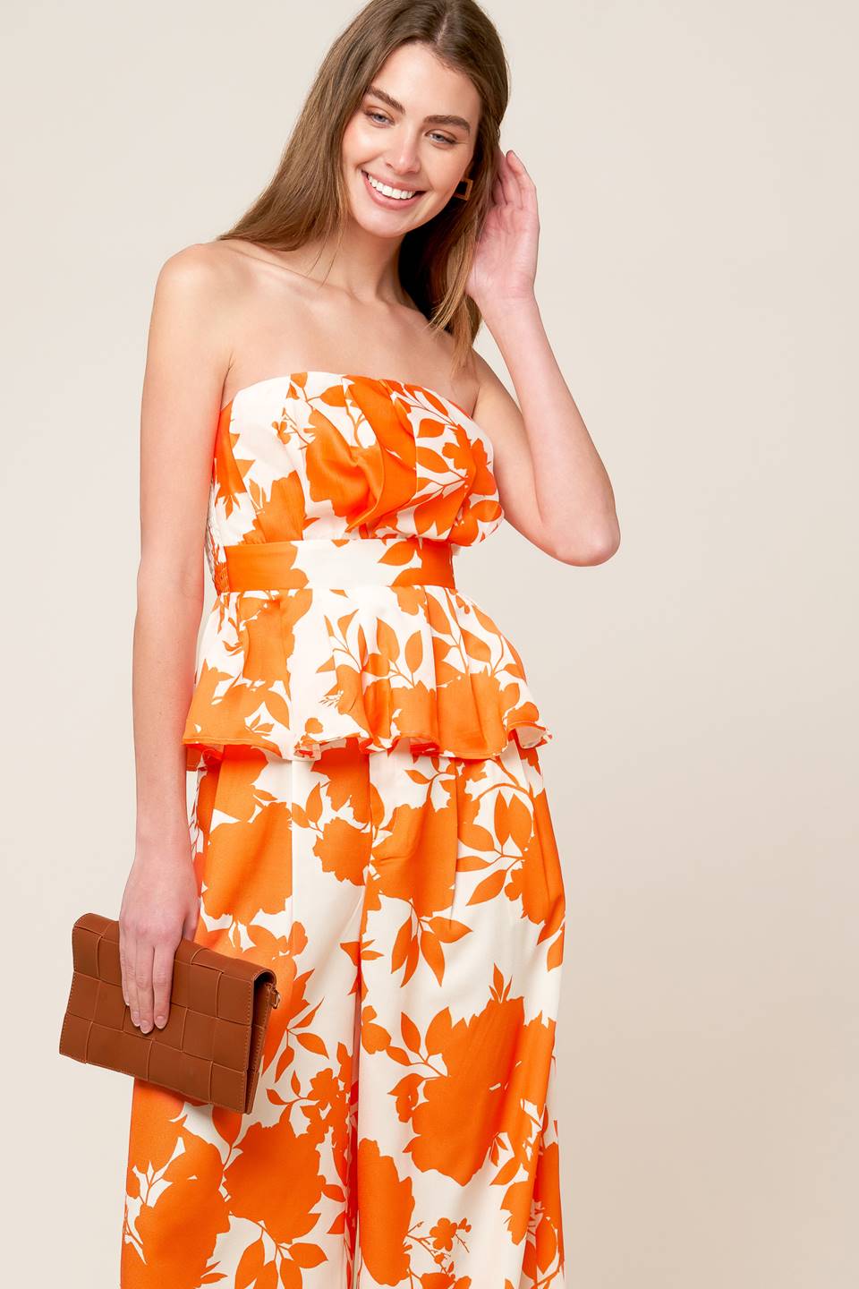 A white and orange, strapless, printed woven top featuring box pleats, peplum and smocked back bodice.