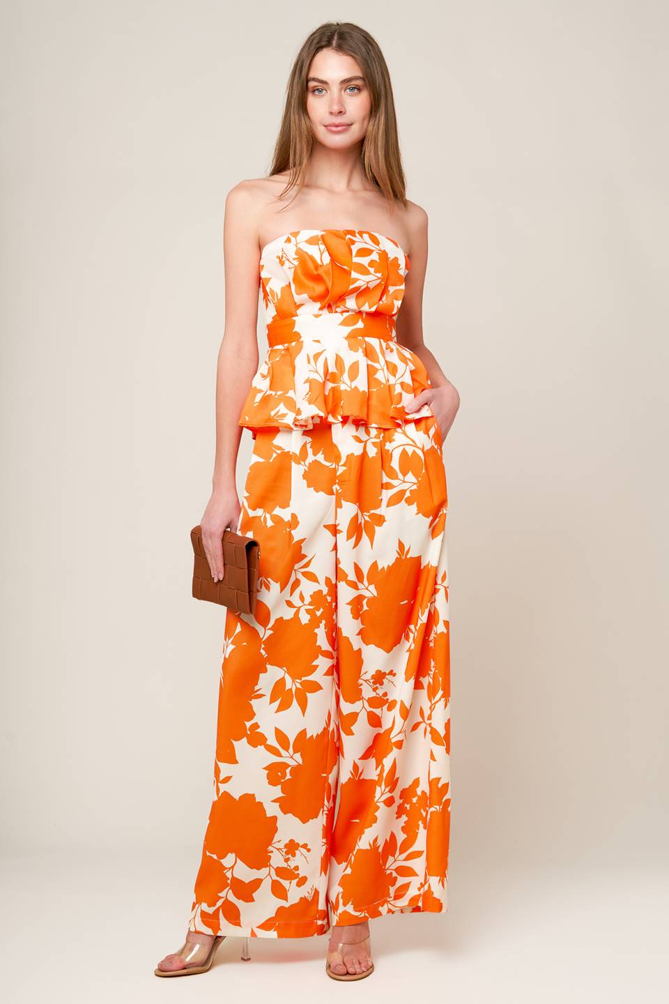 A white and orange, strapless, printed woven top featuring box pleats, peplum and smocked back bodice.