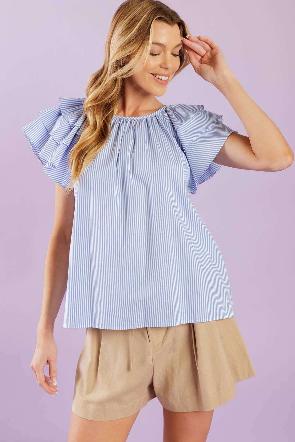 A woven top with stripes, a round neckline, and layered short sleeves, all finished off with a back neck button closure.