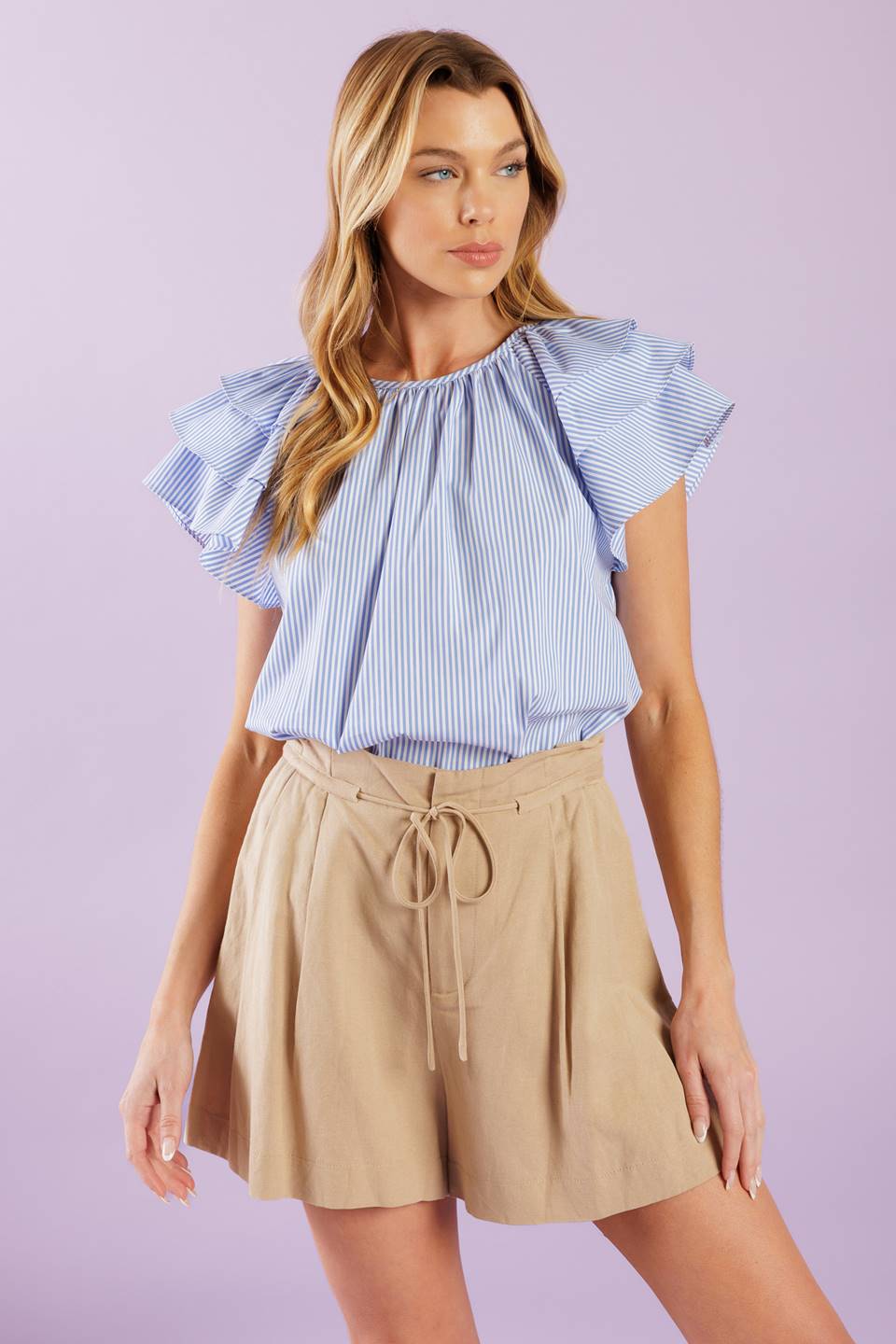 A woven top with stripes, a round neckline, and layered short sleeves, all finished off with a back neck button closure.