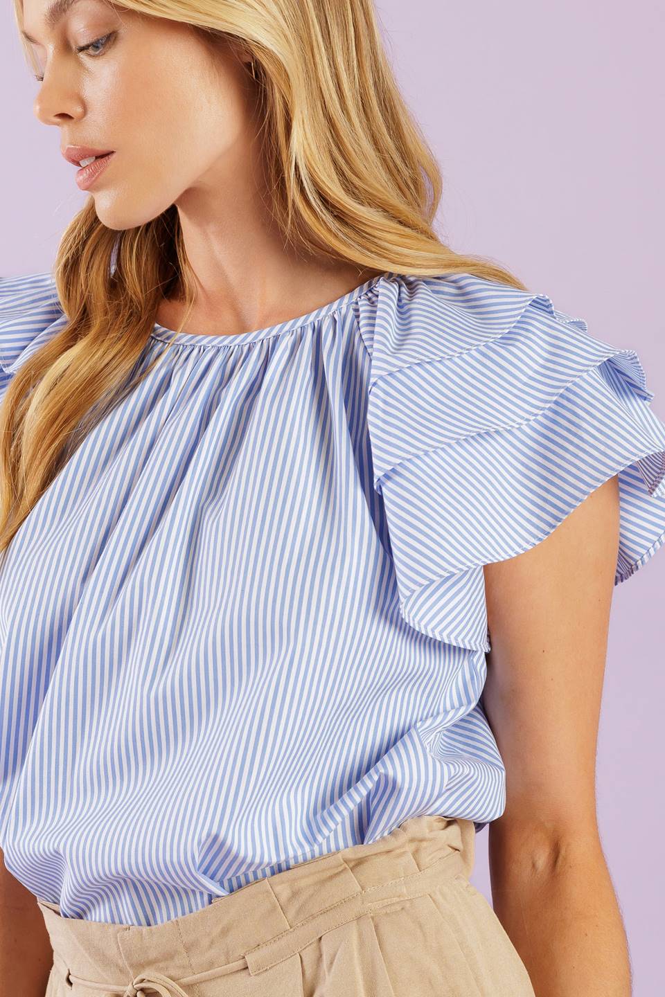 A woven top with stripes, a round neckline, and layered short sleeves, all finished off with a back neck button closure.