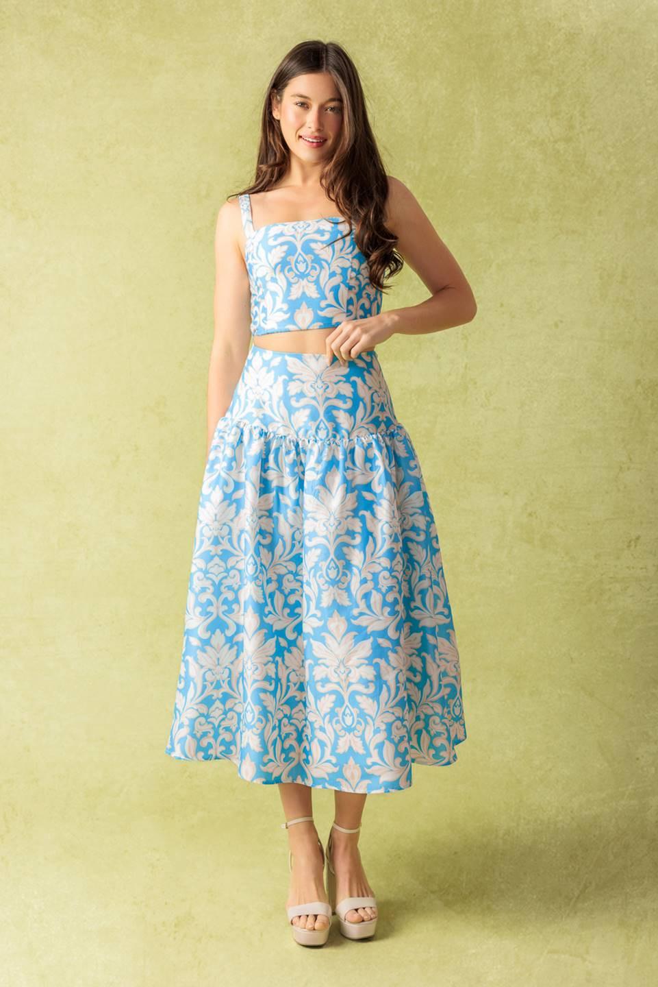 A printed woven top and skirt set. Top featuring a straight neckline, shoulder straps, and smocked back bodice. Full skirt with back zipper closure