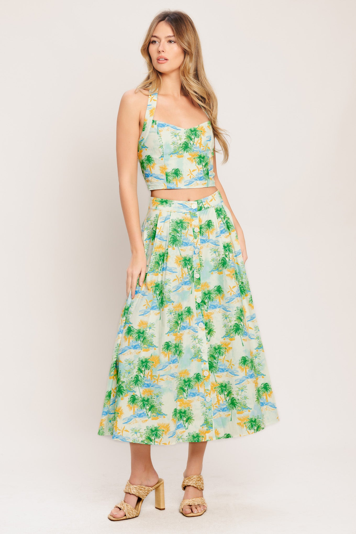A printed woven top and skirt set. Top featuring halter neckline with smocked back bodice. Full skirt with front button down.

Details:

Self : 100% Cotton
Lining : 100% Polyester

Size &amp; Fit

- Model is 5`8" And Wearing Size Small
- Measurements Taken From Size Small
- Approx. Length: 18" (TOP)
- Approx. Length: 34" (BOTTOM)