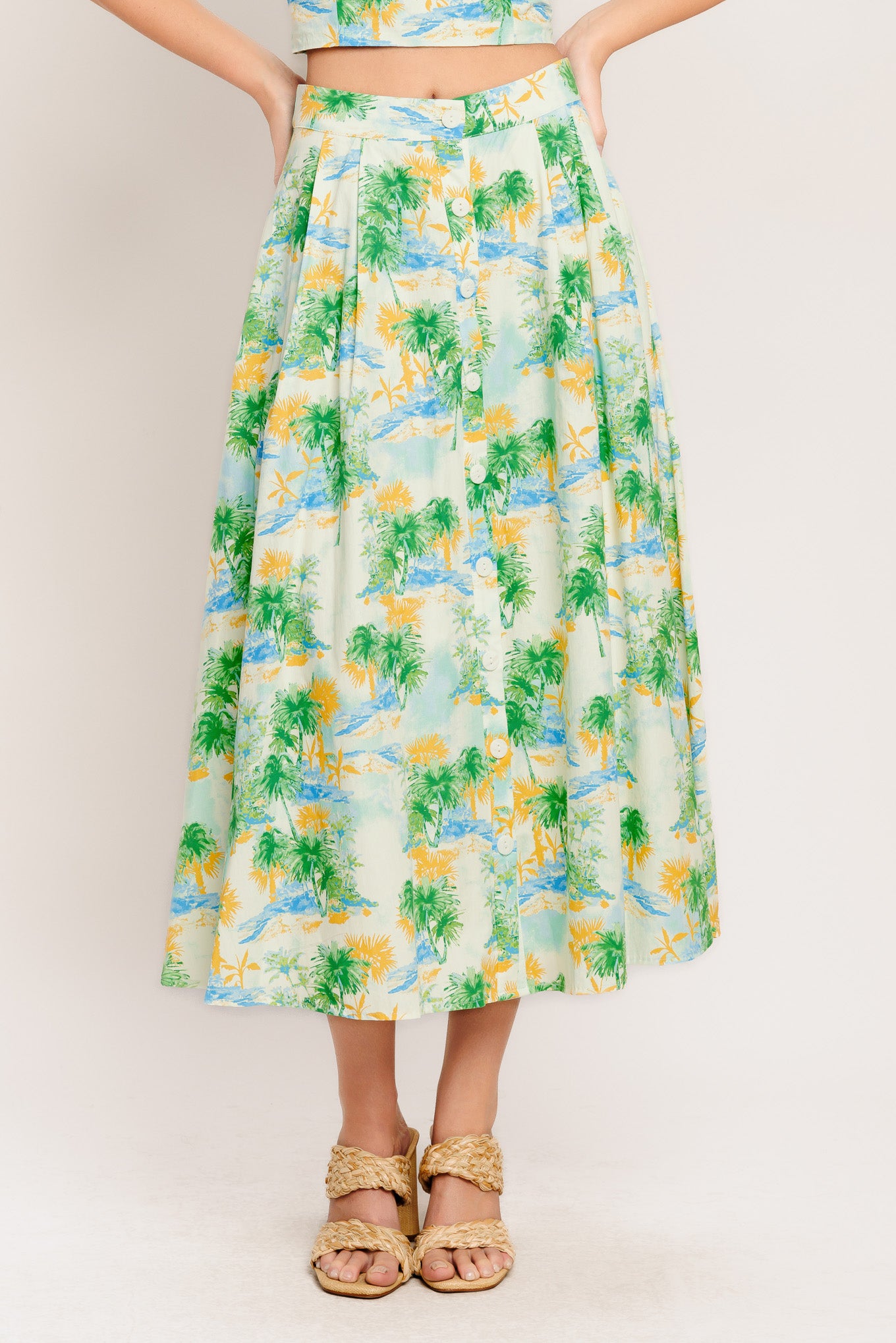 A printed woven top and skirt set. Top featuring halter neckline with smocked back bodice. Full skirt with front button down.

Details:

Self : 100% Cotton
Lining : 100% Polyester

Size &amp; Fit

- Model is 5`8" And Wearing Size Small
- Measurements Taken From Size Small
- Approx. Length: 18" (TOP)
- Approx. Length: 34" (BOTTOM)