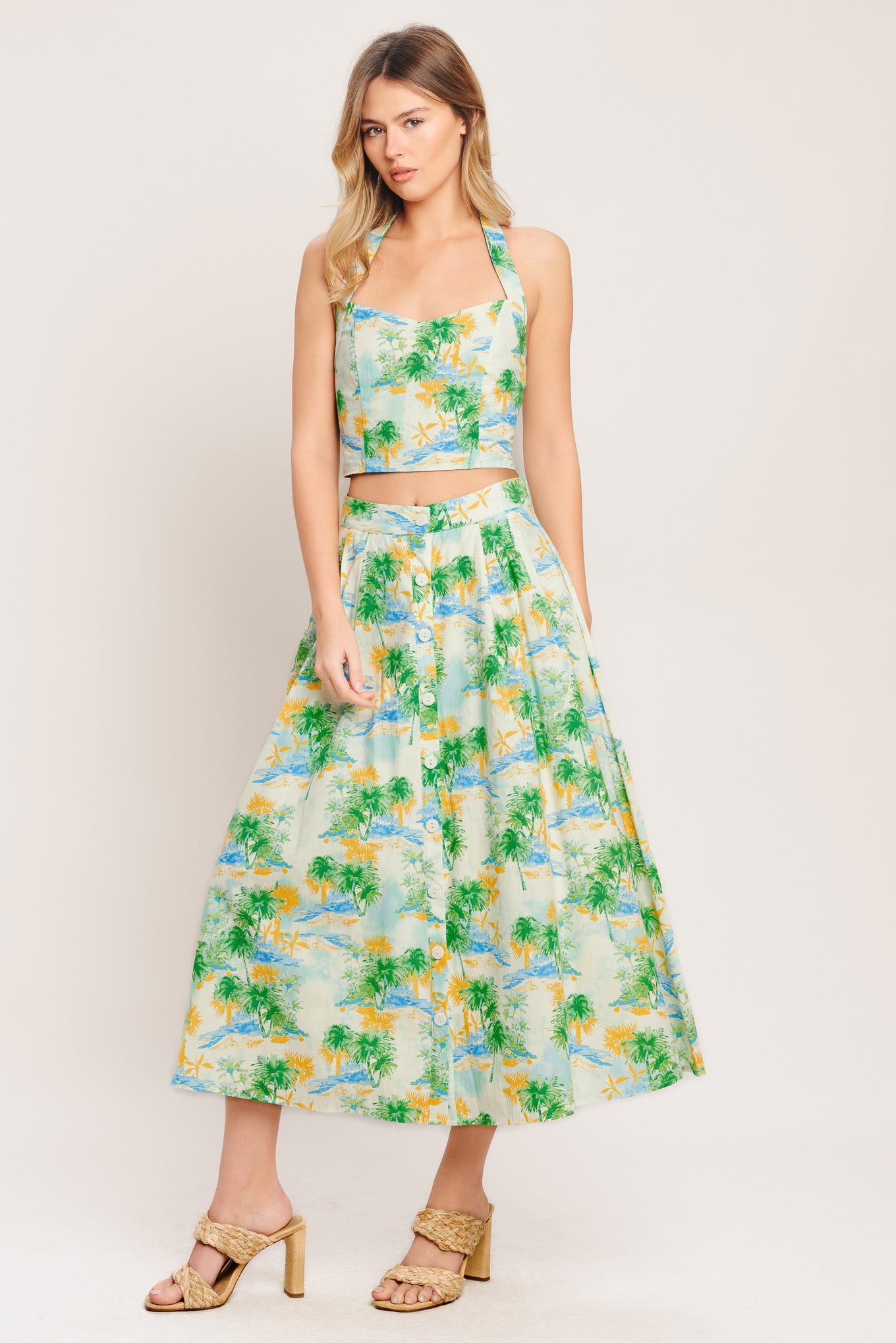 A printed woven top and skirt set. Top featuring halter neckline with smocked back bodice. Full skirt with front button down.

Details:

Self : 100% Cotton
Lining : 100% Polyester

Size &amp; Fit

- Model is 5`8" And Wearing Size Small
- Measurements Taken From Size Small
- Approx. Length: 18" (TOP)
- Approx. Length: 34" (BOTTOM)