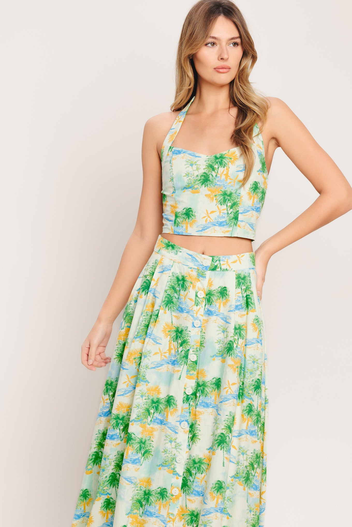 A printed woven top and skirt set. Top featuring halter neckline with smocked back bodice. Full skirt with front button down.

Details:

Self : 100% Cotton
Lining : 100% Polyester

Size &amp; Fit

- Model is 5`8" And Wearing Size Small
- Measurements Taken From Size Small
- Approx. Length: 18" (TOP)
- Approx. Length: 34" (BOTTOM)