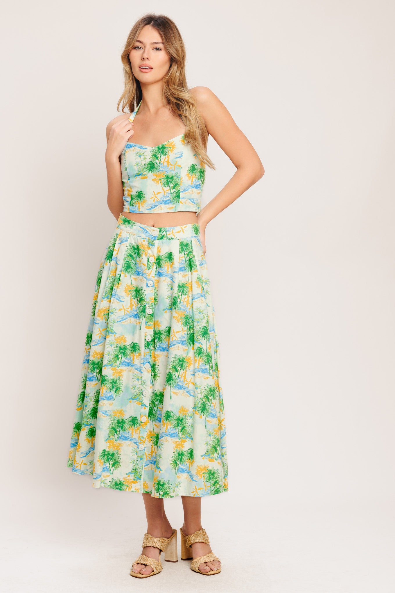 A printed woven top and skirt set. Top featuring halter neckline with smocked back bodice. Full skirt with front button down.

Details:

Self : 100% Cotton
Lining : 100% Polyester

Size &amp; Fit

- Model is 5`8" And Wearing Size Small
- Measurements Taken From Size Small
- Approx. Length: 18" (TOP)
- Approx. Length: 34" (BOTTOM)