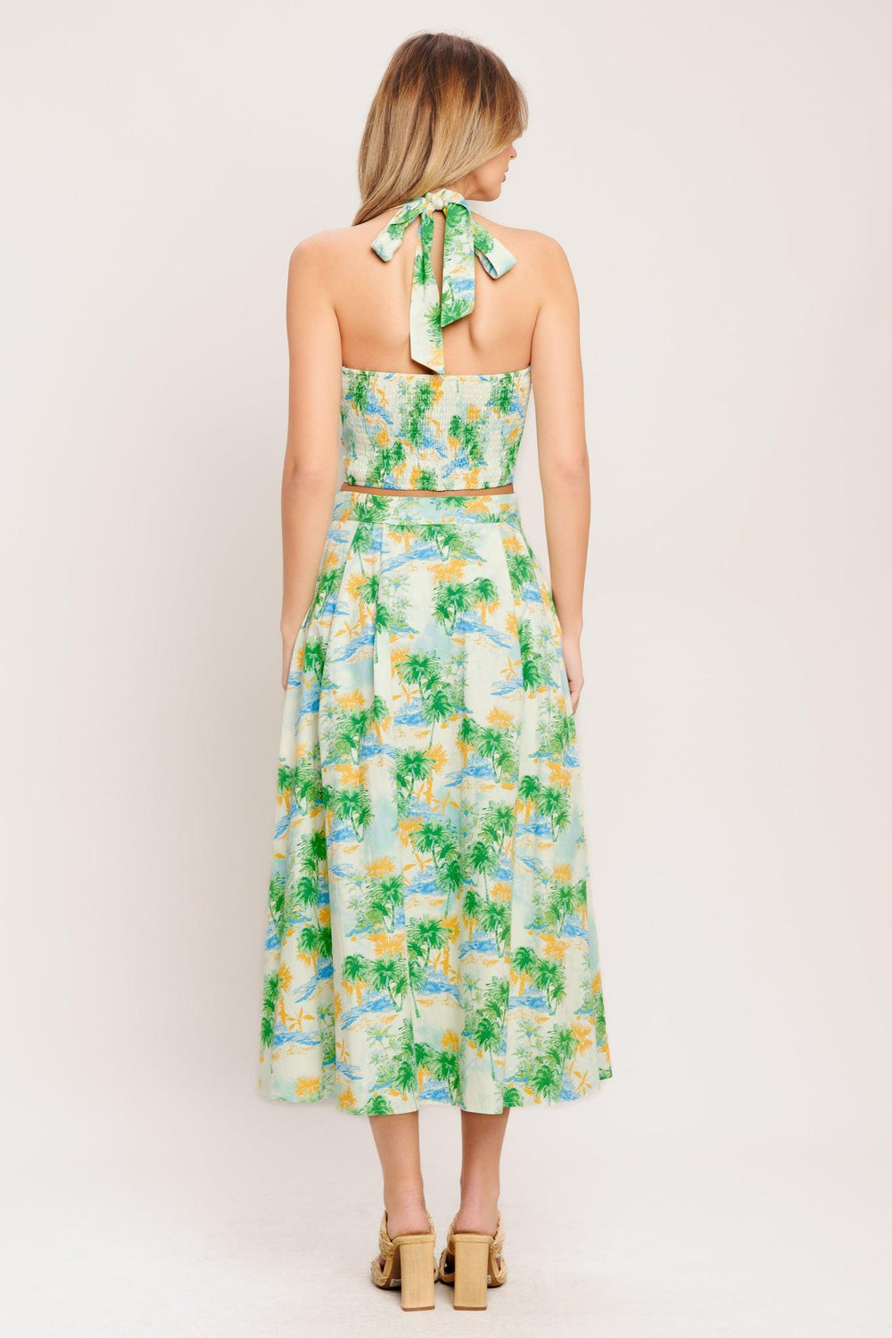 A printed woven top and skirt set. Top featuring halter neckline with smocked back bodice. Full skirt with front button down.

Details:

Self : 100% Cotton
Lining : 100% Polyester

Size &amp; Fit

- Model is 5`8" And Wearing Size Small
- Measurements Taken From Size Small
- Approx. Length: 18" (TOP)
- Approx. Length: 34" (BOTTOM)