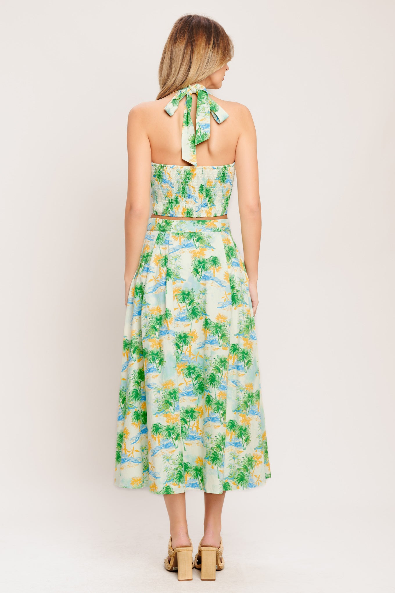 A printed woven top and skirt set. Top featuring halter neckline with smocked back bodice. Full skirt with front button down.

Details:

Self : 100% Cotton
Lining : 100% Polyester

Size &amp; Fit

- Model is 5`8" And Wearing Size Small
- Measurements Taken From Size Small
- Approx. Length: 18" (TOP)
- Approx. Length: 34" (BOTTOM)