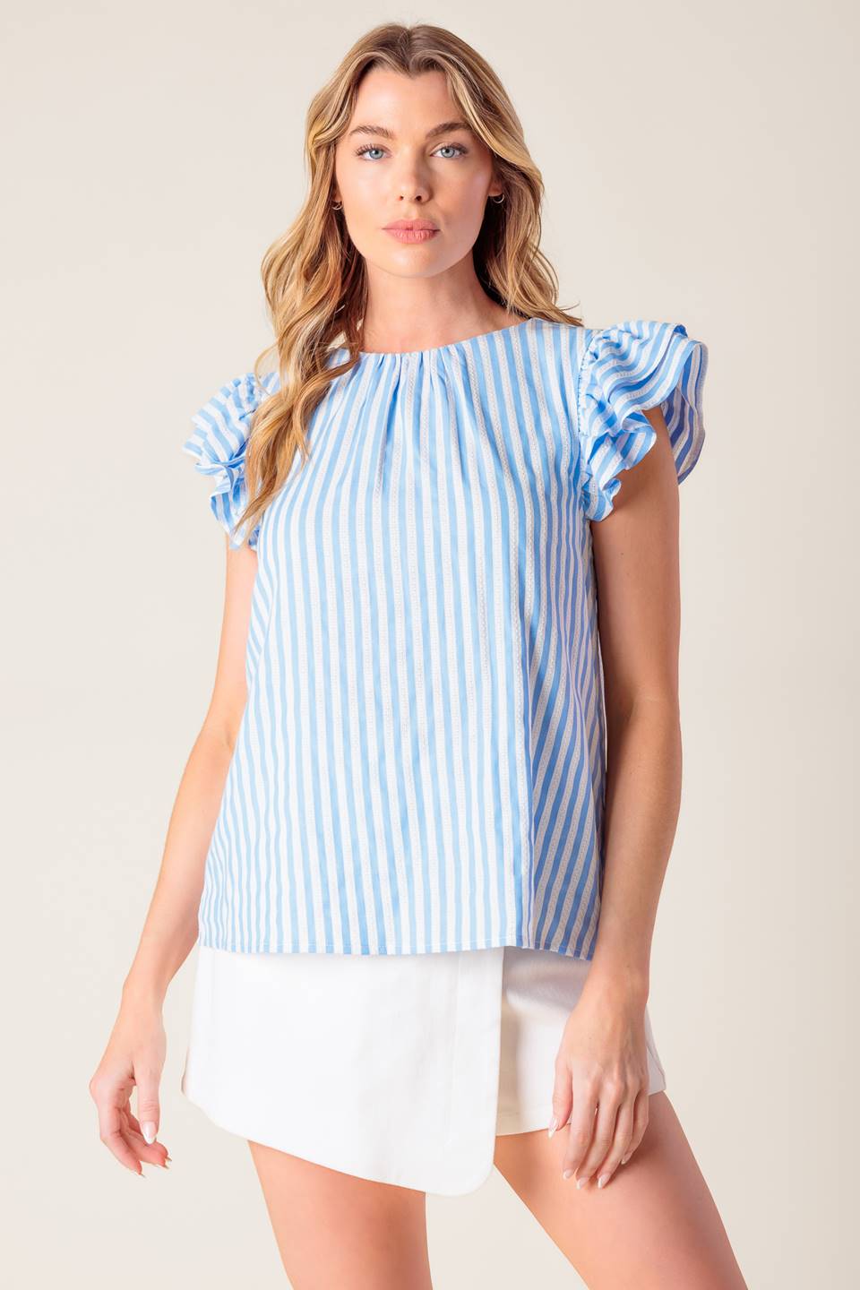 A blue and white textured woven top featuring round neckline, double layer ruffled sleeve and back neck button closure.