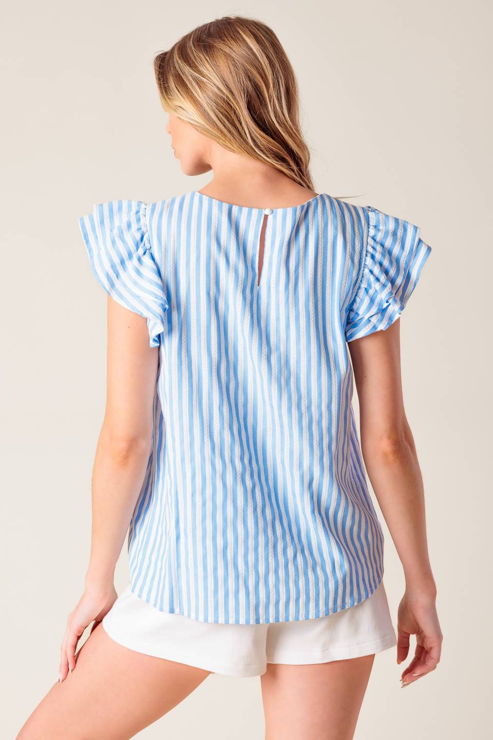 A blue and white textured woven top featuring round neckline, double layer ruffled sleeve and back neck button closure.