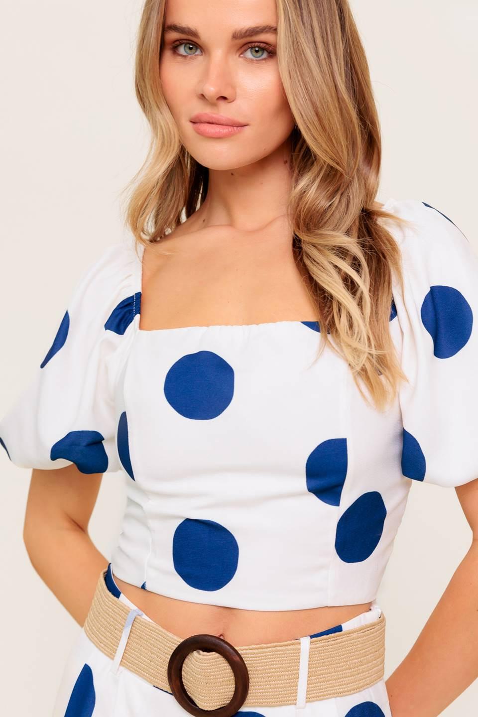 A printed top and pant set. Top featuring square neckline, short puff sleeve and smocked back bodice. Pant featuring side leg with side zipper closure.