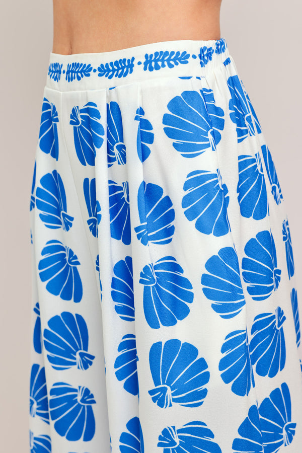 Woman wearing a blue and white patterned top and pant set | Flying Tomato